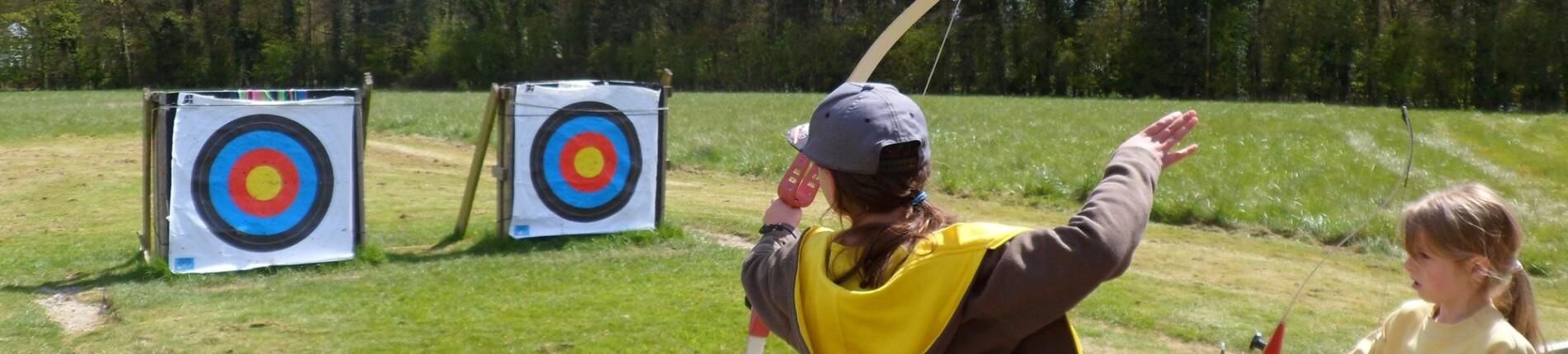 Brownies doing archery